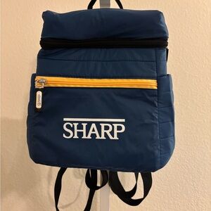 Blue Backpack with Yellow Accent. Brand new with pockets on the sides